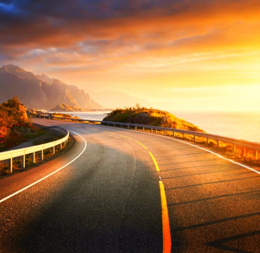 a highway road with a sunset setting