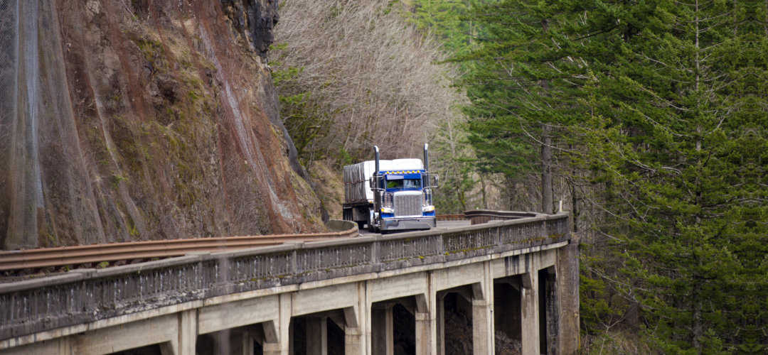 a truck traveling on a mountainside
